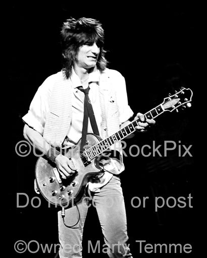 Black and white photo of guitarist Ron Wood of The Rolling Stones playing a Zemaitis guitar in concert in 1979 by Marty Temme
