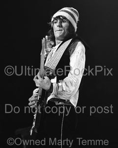 Photo of guitarist Ron Wood of The Faces playing a Fender Stratocaster in concert in 1973 by Marty Temme