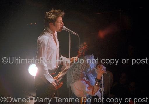 Photo of John Doe of the punk rock band X in concert in 1981 by Marty Temme