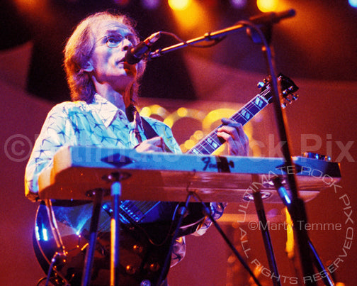 Photo of guitarist Steve Howe of Yes playing a pedal steel guitar in concert by Marty Temme