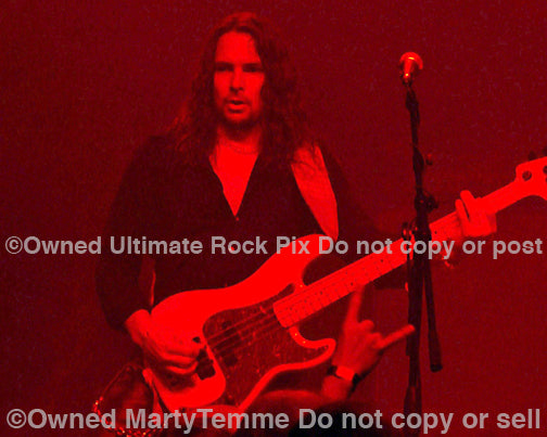 Photo of bassist Bjorn Englen of Yngwie Malmsteen in concert in 2008 by Marty Temme