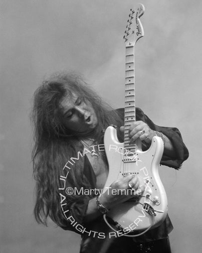 Black and white photo of guitar player Yngwie Malmsteen in concert by Marty Temme