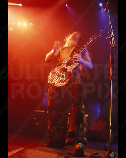 Photo of Zakk Wylde of Ozzy Osbourne playing his Les Paul in concert in 1991 by Marty Temme