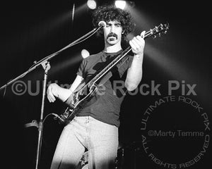 Photo of Frank Zappa playing a Gibson SG in 1973 by Marty Temme