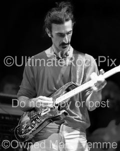 Black and white photo of Frank Zappa playing a Stratocaster in concert in 1978 by Marty Temme