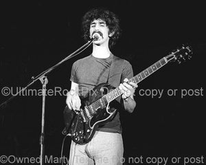 Black and white photo of Frank Zappa playing a Gibson SG in 1973 by Marty Temme